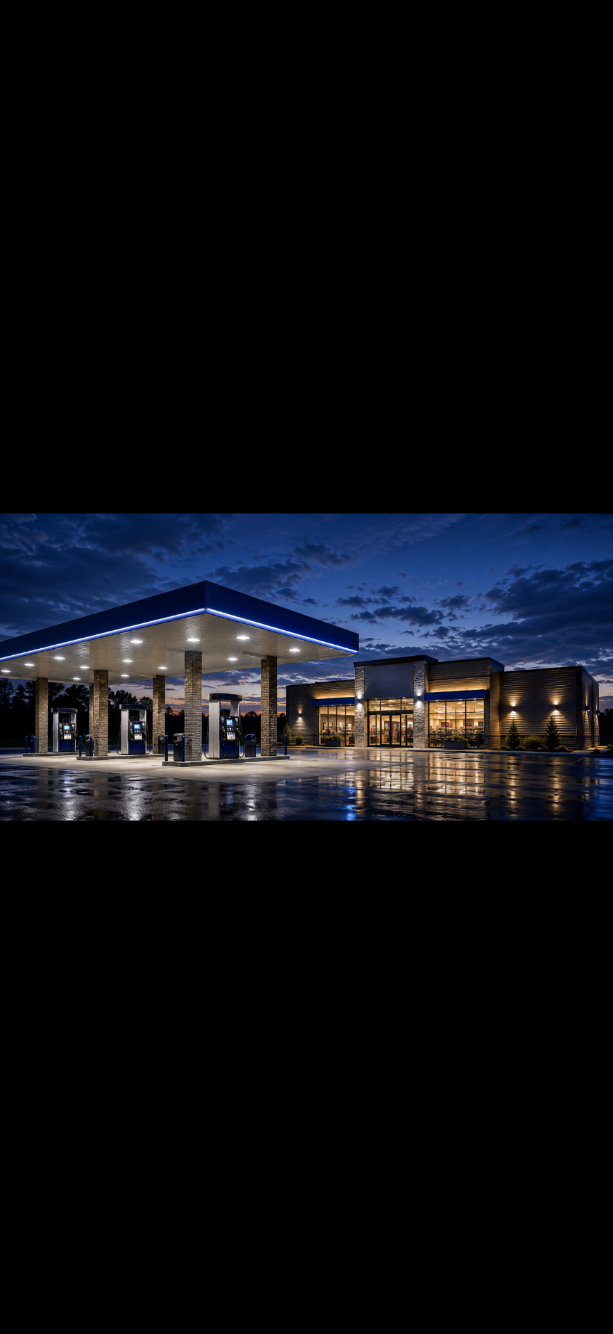 Modern convenience store and fuel canopy at dusk